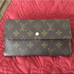 Louis Vuitton trifold long wallet.